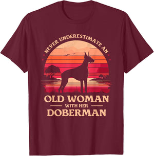 Never Underestimate An Old Woman With Her Doberman Dobie T-Shirt - T-Shirt | Maroon